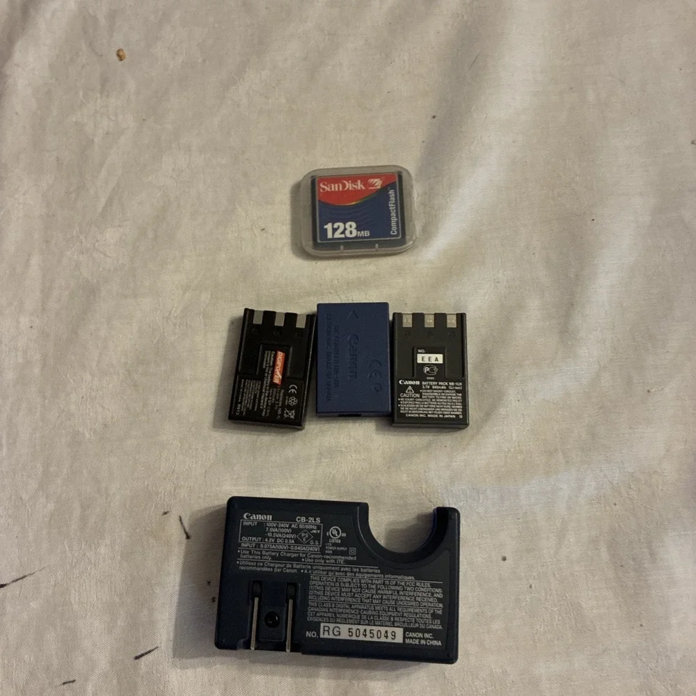 canon battery charger CB-2LS, 3 batteries, And One Sim Card Working